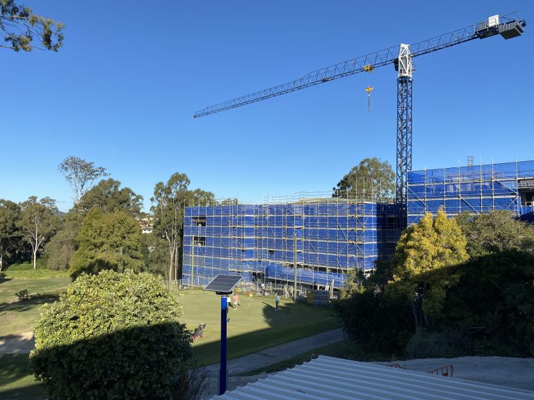 Construction at Fairway Carindale shows a building site with scaffolding on both building 1 and 2 and a crane on the golf course.
